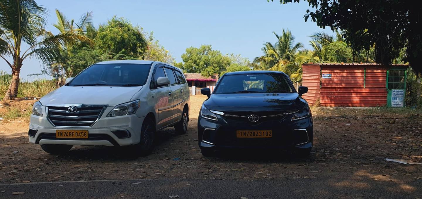 Our white Toyota Innova and grey Toyota Glanza parked side by side